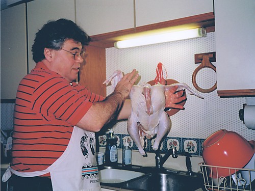 BEFORE John prepares a chicken at the sink.